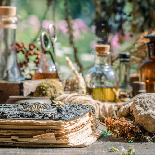 Bottles of oil and herbs in the background 